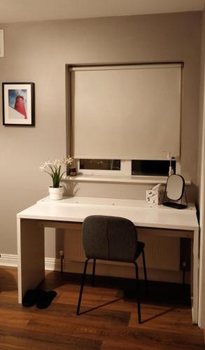 a white desk with a chair and a window at En-Suite room in Carlow Town in Carlow