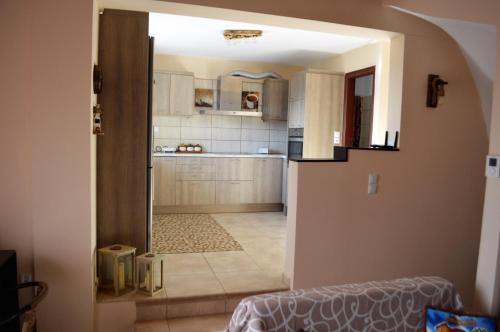 a kitchen with an open door to a room at Τα πέτρινα στο Σκεπαστό in Kalavrita