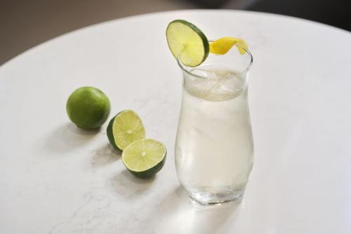 a glass of margarita with lime and limes on a table at Residence Inn by Marriott Oakland Downtown in Oakland