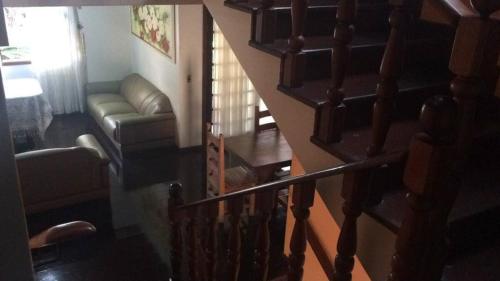 a staircase leading up to a living room with a couch at CASA DO LAGOO in Londrina