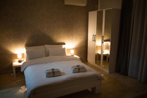 a bedroom with a bed with two bags on it at La Mirage in Šabac
