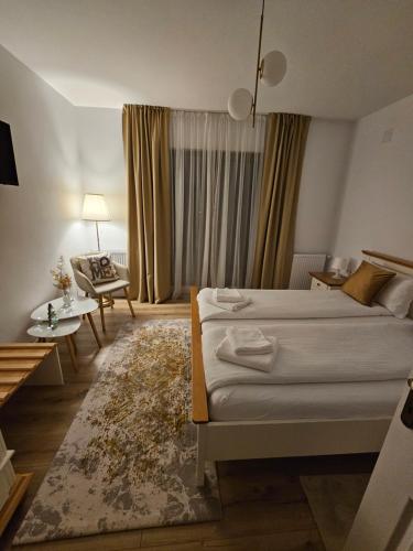 a bedroom with two beds and a living room at Casa Mara Viseu de Sus in Vişeu de Sus