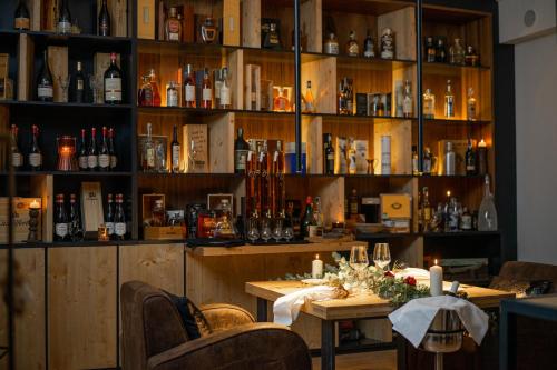 a bar with a table and shelves of bottles at UNA HOTELS Tenuta Contessa Farm & SPA Cosenza in Montalto Uffugo