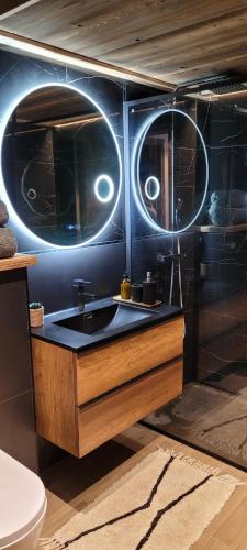 a bathroom with a sink with two eyes on the wall at Les petites chambres St Gervais in Saint-Gervais-les-Bains