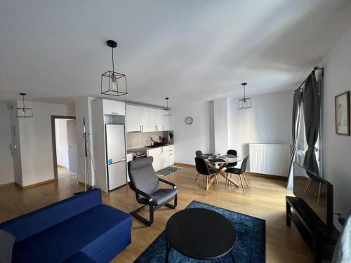 a living room with a blue couch and a table at Iris Luxury Apartment in Ioannina