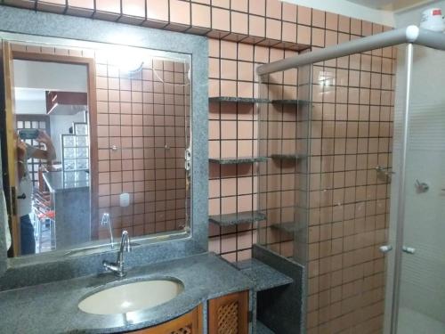 a bathroom with a sink and a mirror at Condomínio das gaivotas in Alcobaça