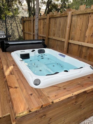a hot tub sitting on top of a wooden deck at Maison proche du pic Saint Loup in Saint-Jean-de-Cuculles