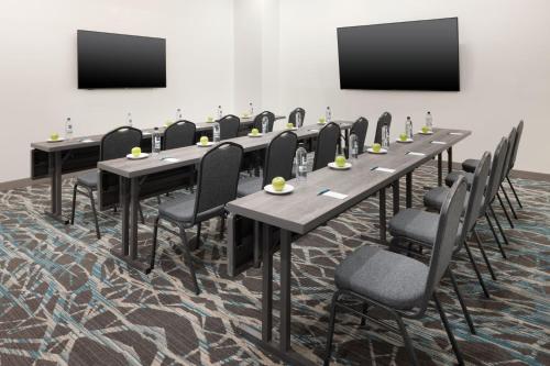 a conference room with long tables and chairs and screens at Element Atlanta Buckhead in Atlanta