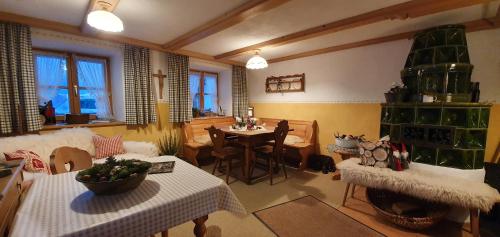 a living room with a table and a dining room at Pension Marianne - Chiemgau Karte in Inzell
