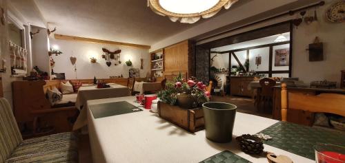 a restaurant with tables with flowers on top of it at Pension Marianne - Chiemgau Karte in Inzell