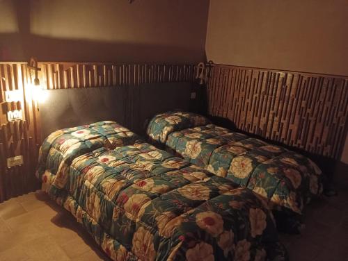 two beds sitting next to each other in a bedroom at Agriturismo Tenuta Filippi in Narni