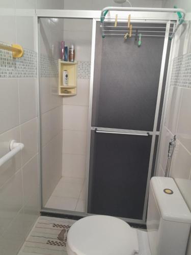 a shower with a glass door in a bathroom at Guarajuba Residence - Flat in Camacari