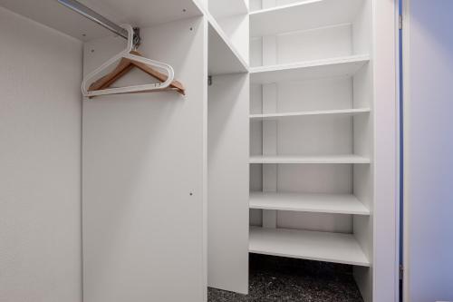 a walk in closet with white shelves at Wohnung mit Dachterrasse in Mörfelden-Walldorf