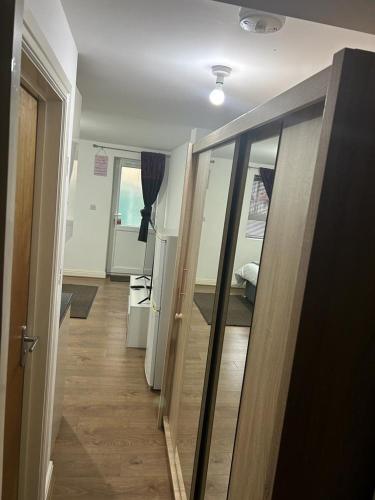 a hallway with a door leading to a bedroom at Hometel Big Luxurious Self Contained Bedsit in Thornton Heath