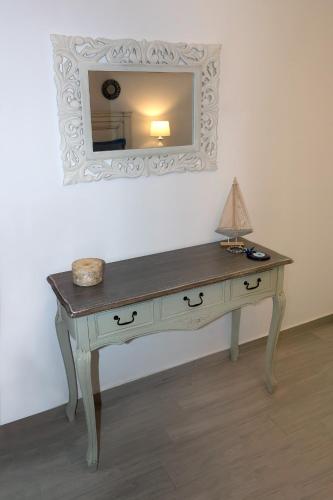 a dressing table with a mirror on a wall at Aelia Luxury Villa in Amoopi