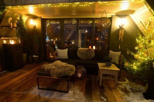 a living room with a couch and a christmas tree at Chata s wellness in Hutisko
