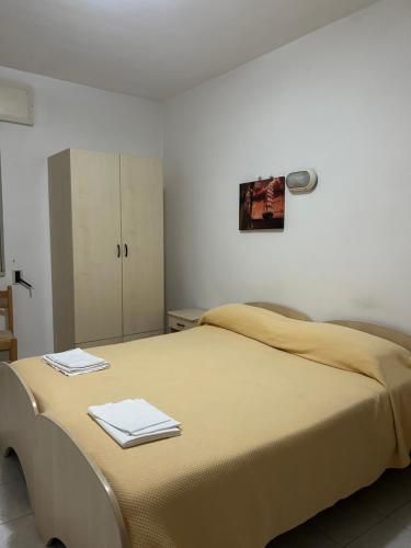 a bedroom with a bed with two towels on it at Albergo pensione Bianco in San Giovanni Rotondo