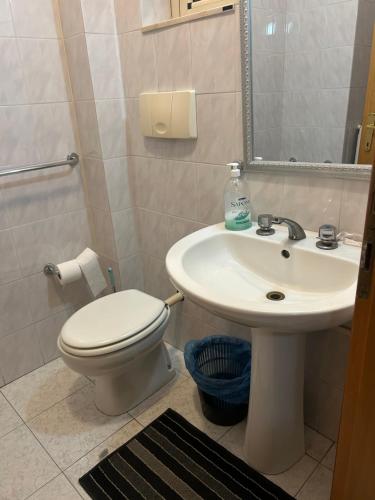 a bathroom with a toilet and a sink at Albergo pensione Bianco in San Giovanni Rotondo