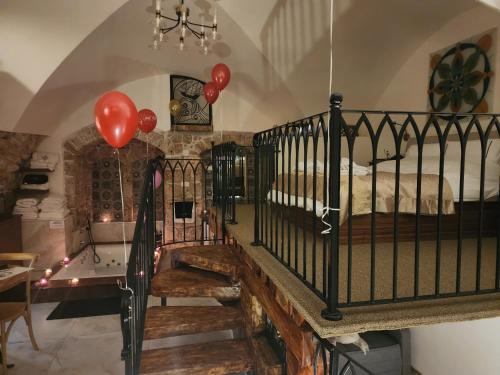 a room with a staircase with balloons and a bed at Templars suite in ‘Akko