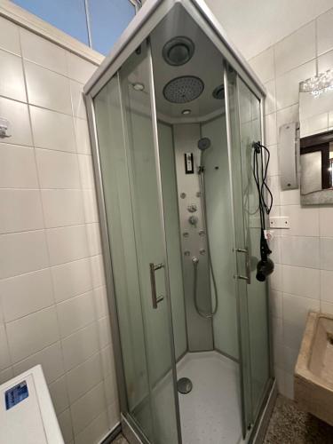 a shower with a glass door in a bathroom at Rosa apartment in Venice