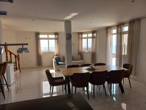 a living room with a wooden table and chairs at Casa Graciosa in Tarrafal