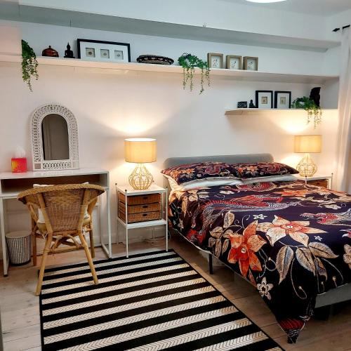 a bedroom with a bed and a desk and a chair at Oriental, 2 Double Bedroom Flat, Royal Greenwich, SE London in London