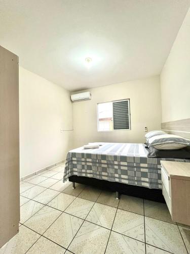 a bedroom with a bed and a window at MORADA GARAPEIRA in Guarda do Embaú