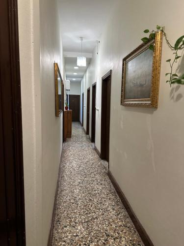 a long hallway with a tile floor and a picture on the wall at Rosa apartment in Venice