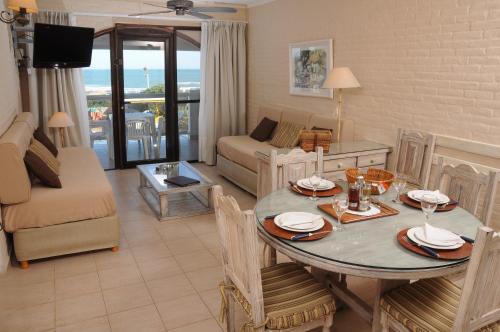 a living room with a dining room table and a couch at Carilo Soleil By HS in Carilo