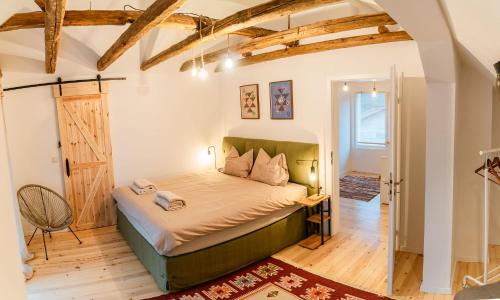 a bedroom with a bed and a wooden floor at Къща за гости РАДЕЯ in Govedartsi
