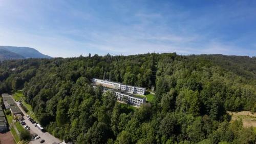 an aerial view of a building in the middle of a forest at MAGIC HILLS in Ustroń