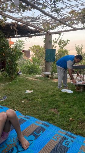 a man and a woman standing in the grass at استراحه أحمد سليم 