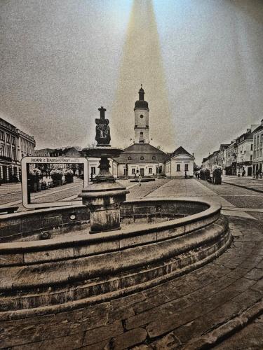 a fountain in front of a building with a pyramid at ApartHotel Centrum - parking free in Białystok
