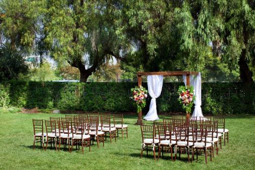 a row of chairs with a wedding altar in a field at Sheraton Fairplex Suites & Conference Center in Pomona