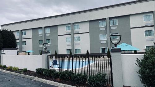 a building with a pool in front of it at Sleep Inn & Suites West Knoxville in Knoxville