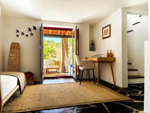 a bedroom with a bed and a desk with birds on the wall at Casa da Loba in Casas Novas de Marés