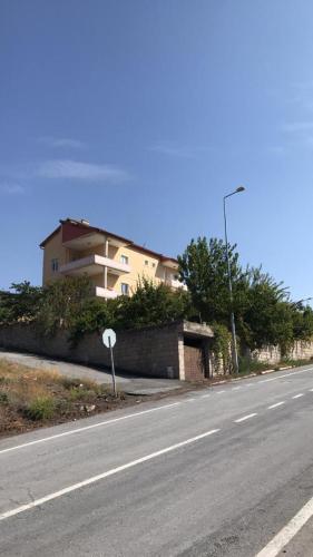 a house on the side of a road next to a street at Periliköşk Rezidans in Talas