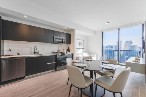 a kitchen and dining room with a table and chairs at Bayside Apartment with Impressive City Views in Miami