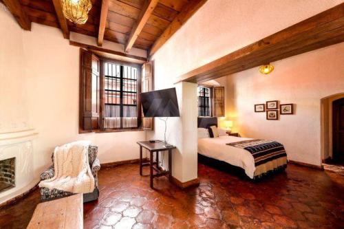 a bedroom with a bed and a fireplace at Eternal Spring in Antigua Guatemala