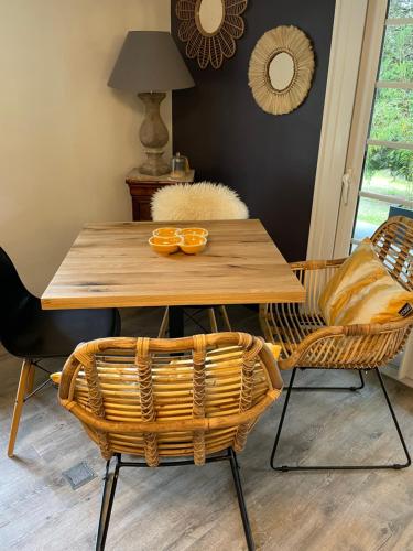 a dining room table with two chairs and a wooden table at Gîte le 27 in Lorp Sentaraille