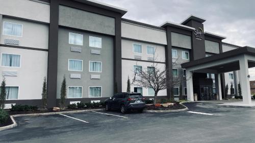 a car parked in a parking lot in front of a building at Sleep Inn & Suites West Knoxville in Knoxville