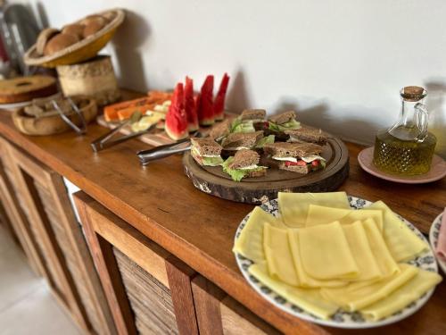 a wooden table topped with plates of sandwiches and other foods at La Bahianita in Itacaré