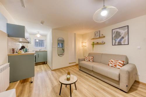 un salon avec un canapé et une table dans l'établissement Le ciné cocon - Serenito Homes, à Les Pavillons-sous-Bois