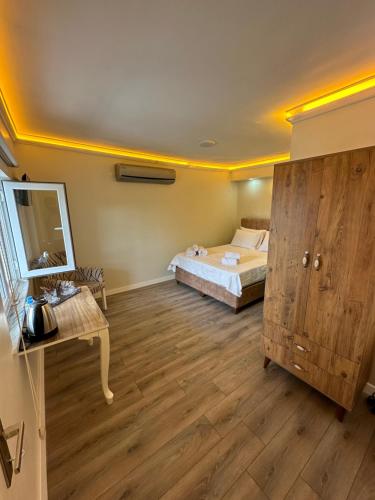 a bedroom with a bed and a dresser in it at Pilot hotel in Arnavutköy