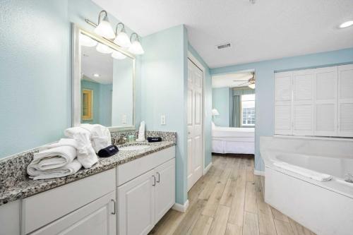 a bathroom with a tub and a sink and a bath tub at Luxury 20th Floor 2 BR Condo Direct Oceanfront Wyndham Ocean Walk Resort Daytona Beach | 2020 in Daytona Beach