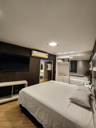 - une chambre avec un grand lit et une télévision à écran plat dans l'établissement Studio no Hotel Bristol 500 - Bairro Batel, à Curitiba