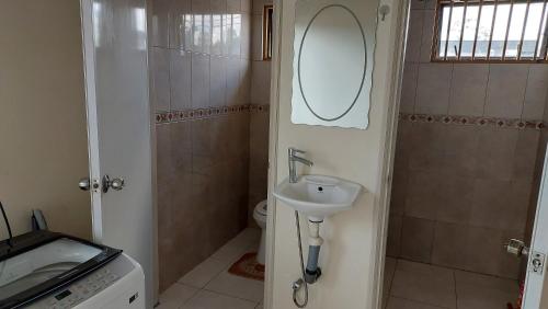 a small bathroom with a sink and a toilet at Apartment Julia in Paramaribo