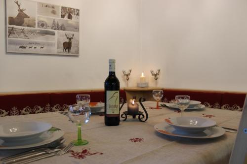 a bottle of wine sitting on a table with glasses at Märchenschlössel Altenstein in Trebesing