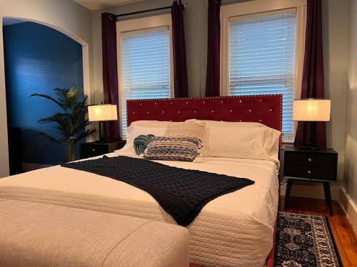 a bedroom with a large bed with two windows at Cozy as a Sunday - 2/BR sleep 6 in Everett