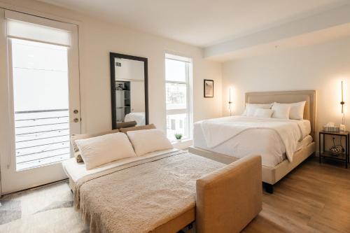 a bedroom with a large bed and a window at Elegant Apartment in the Heart of Hollywood in Los Angeles